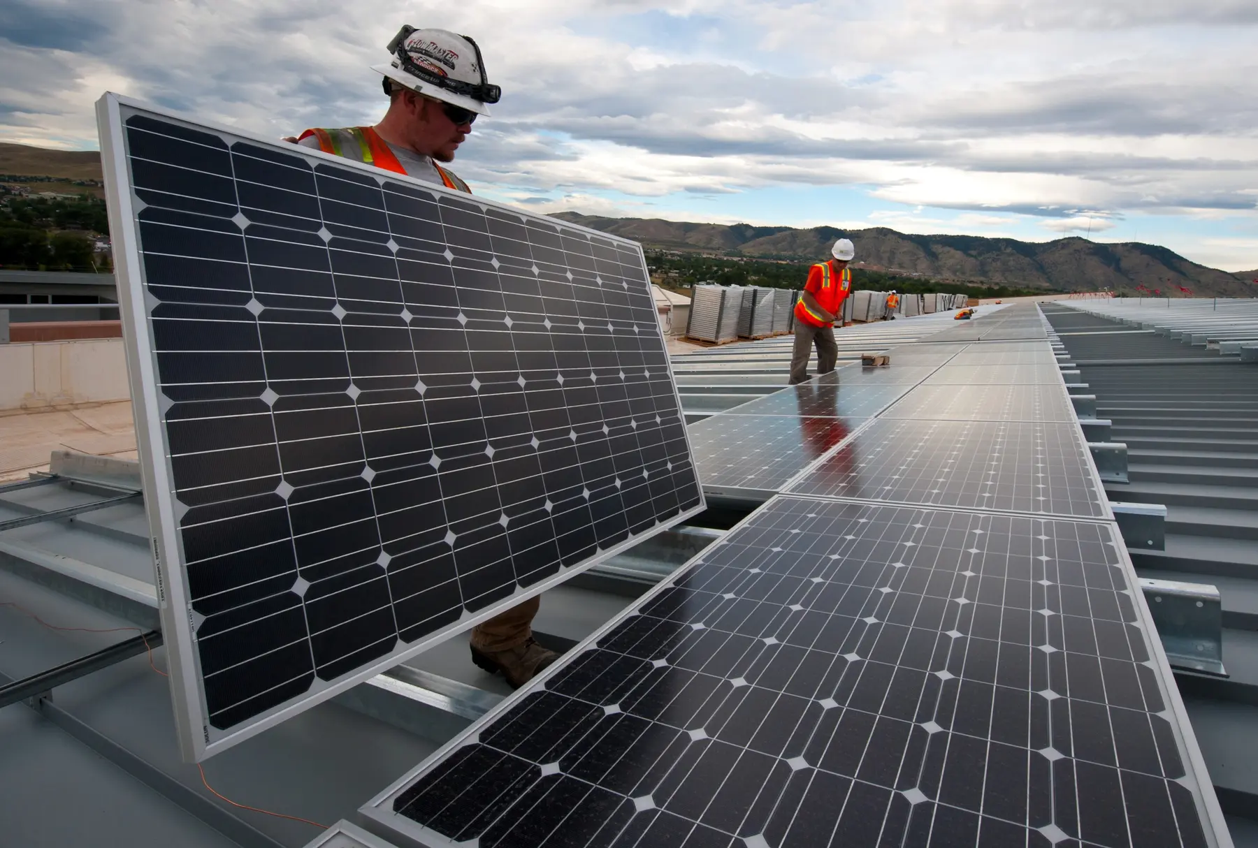 Brian Lawson and Kenesaw Burwell work on a solar-panel installation featured by the U.S. Department of Energy, June 4, 2012.
