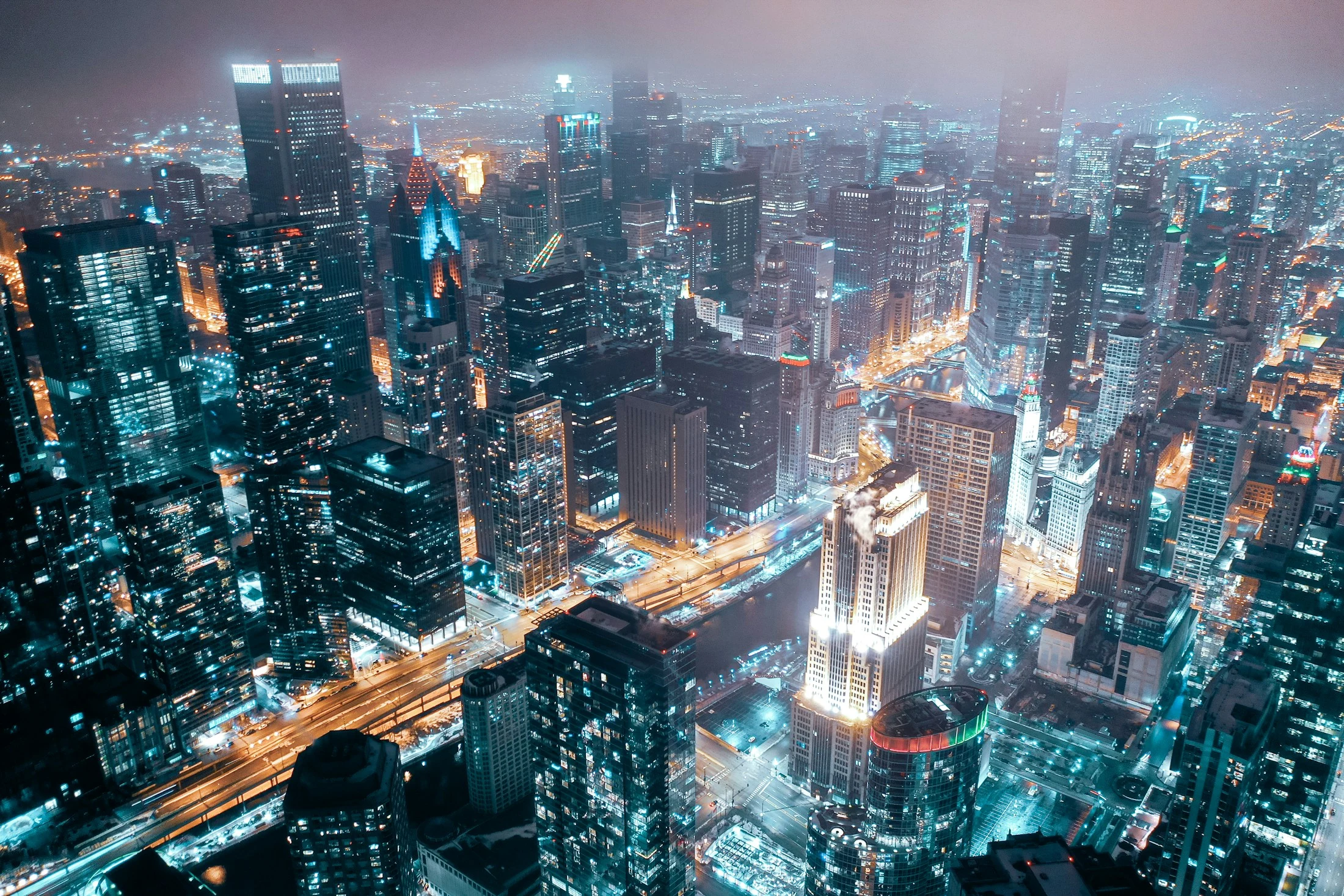 Chicago skyline and streets illuminated at night.