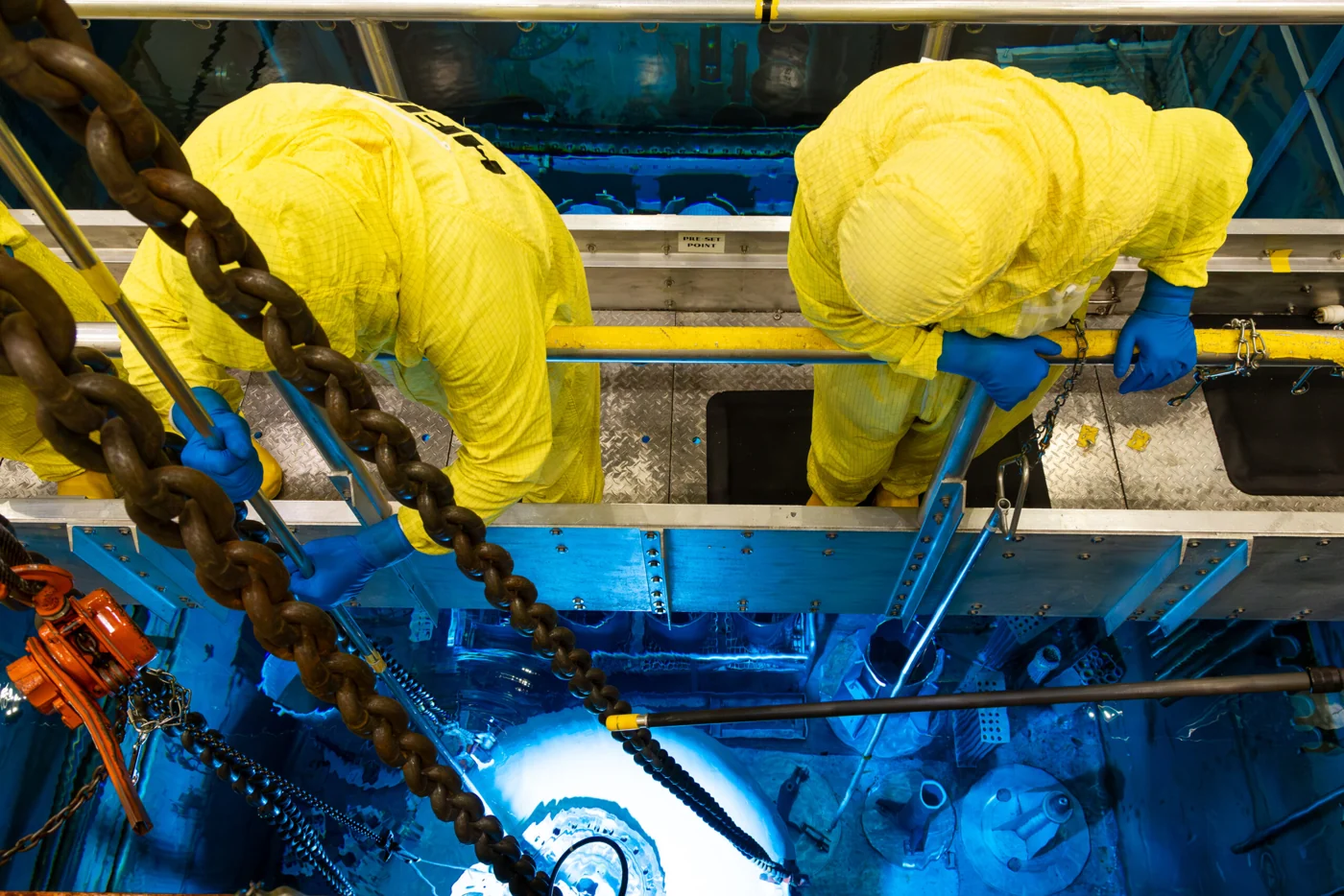 Operators work above the blue-glowing pool of Oak Ridge National Laboratory’s High Flux Isotope Reactor.