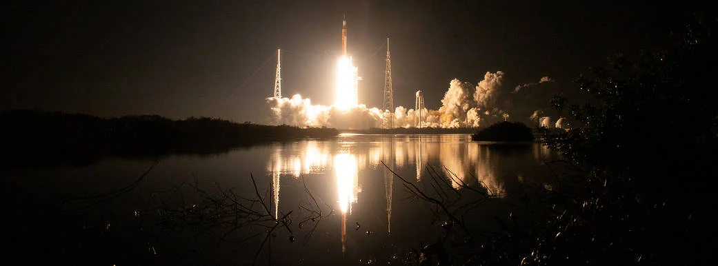 Artemis I launches from Kennedy Space Center, carrying Orion toward the Moon.